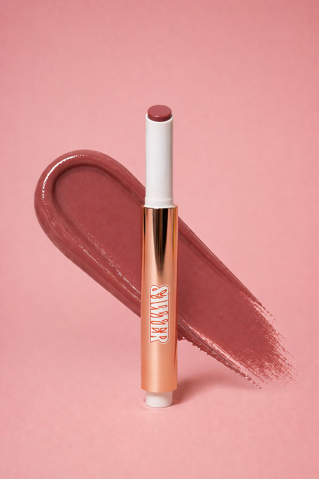 Lipstick with a swatch of color on a pink background