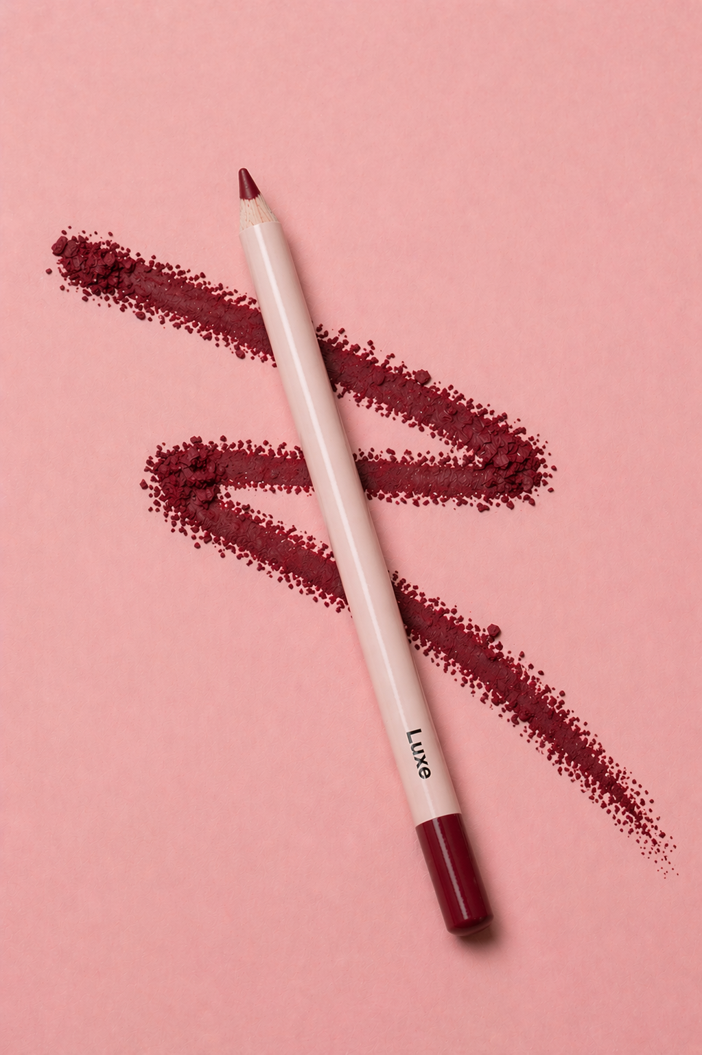 Lip liner pencil with smudges of red lipstick on a pink background